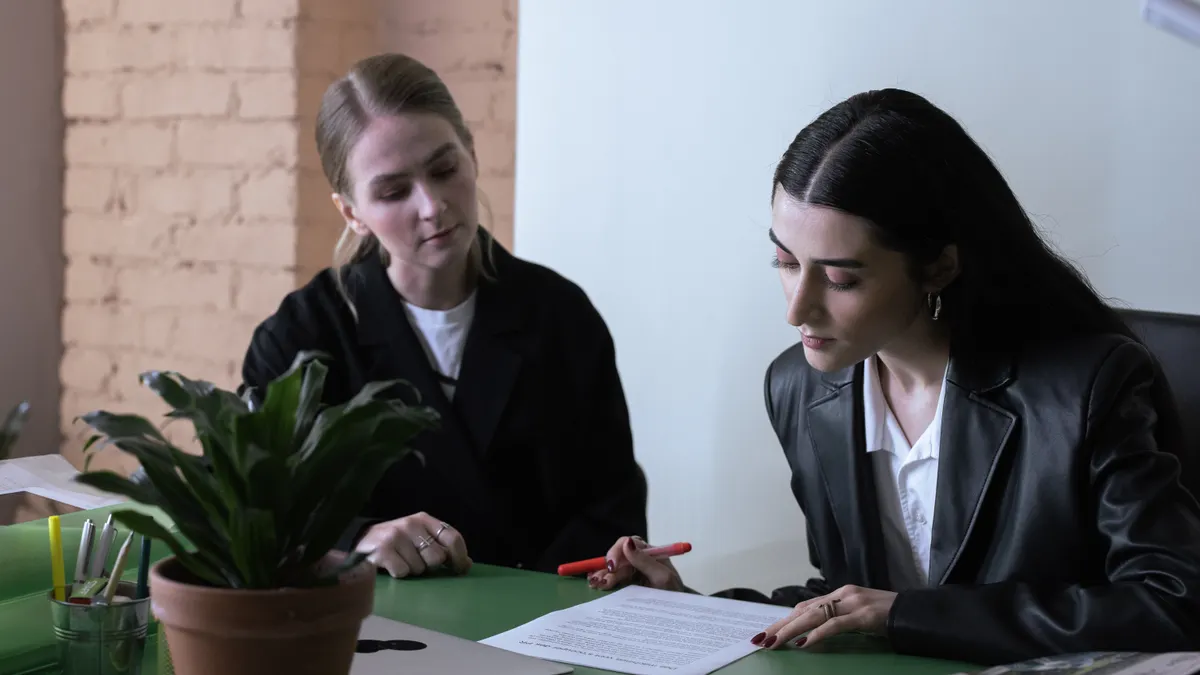 two people reviewing a document together