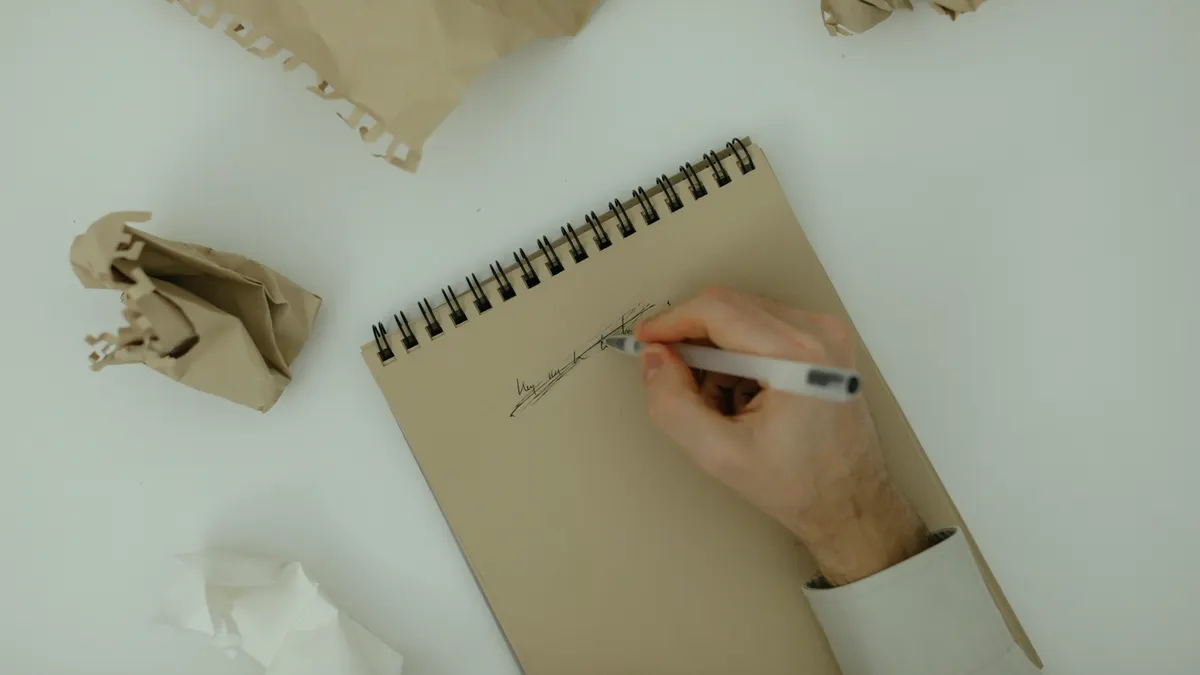 How to edit and refine drafts in article writing software — Crumpled Papers Near A Person Writing On A Notepad
