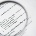 magnifying glass over a document with bullet points